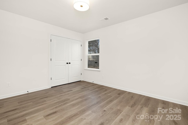 empty room with hardwood / wood-style flooring