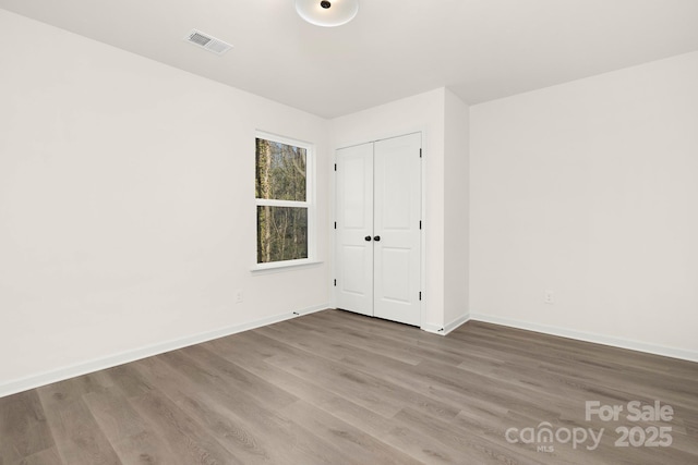 spare room featuring wood-type flooring