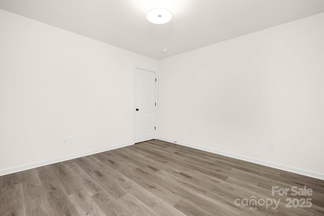 unfurnished room with wood-type flooring