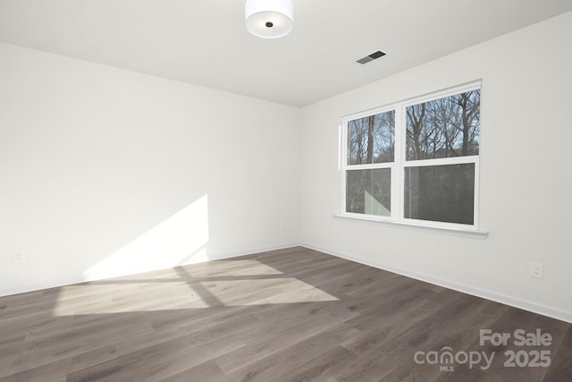 unfurnished room with wood-type flooring