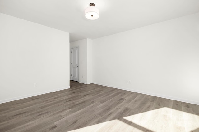 empty room with dark wood-type flooring