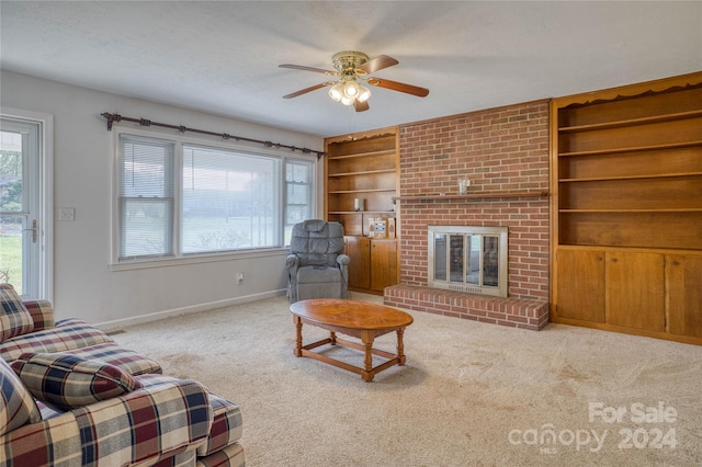 carpeted living room featuring built in shelves, a fireplace, a textured ceiling, and ceiling fan