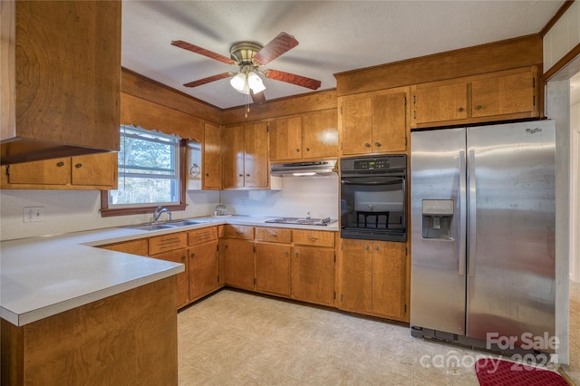 kitchen featuring appliances with stainless steel finishes, sink, ceiling fan, and a textured ceiling