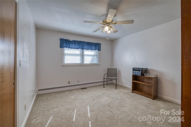 carpeted empty room with a baseboard radiator and ceiling fan