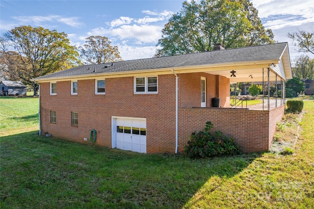 view of home's exterior featuring a garage, a lawn, and ceiling fan