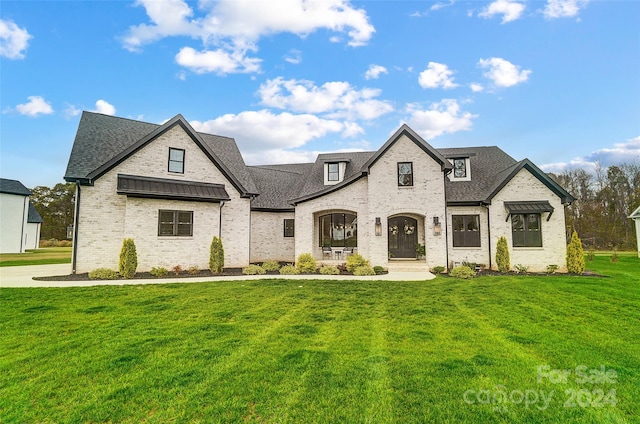 french provincial home with a front lawn