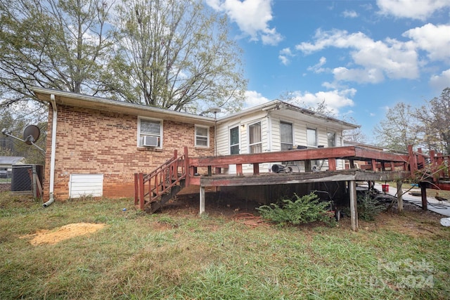 rear view of house with cooling unit and a deck