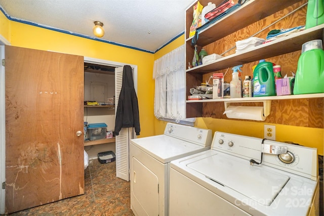 washroom featuring washer and clothes dryer and a textured ceiling