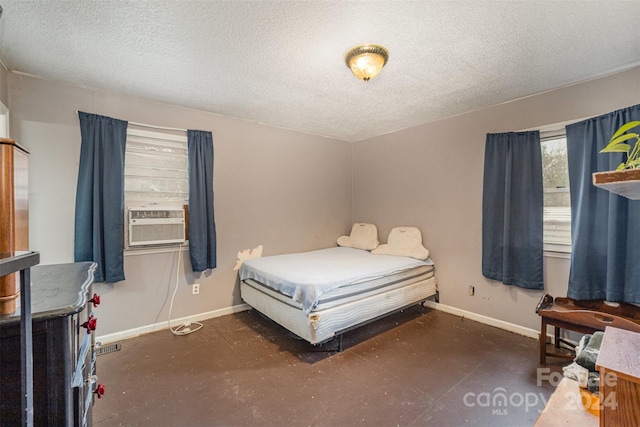 bedroom featuring cooling unit and a textured ceiling