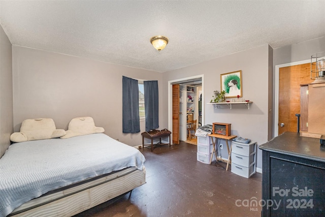 bedroom featuring a textured ceiling and a closet