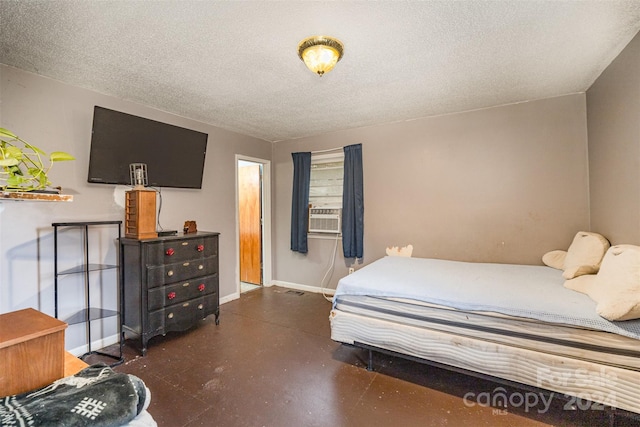 bedroom featuring cooling unit and a textured ceiling