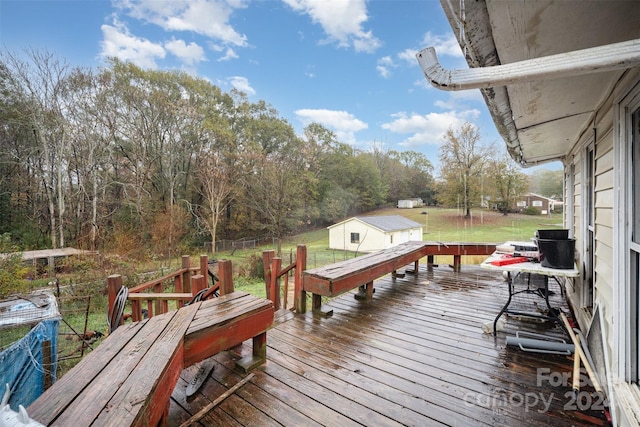 wooden deck with a yard and an outdoor structure