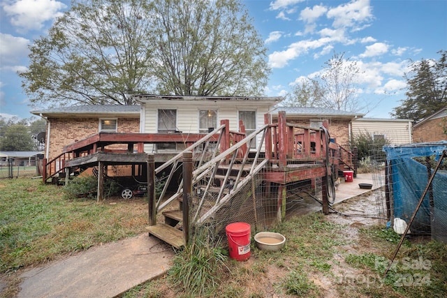 back of property featuring a deck