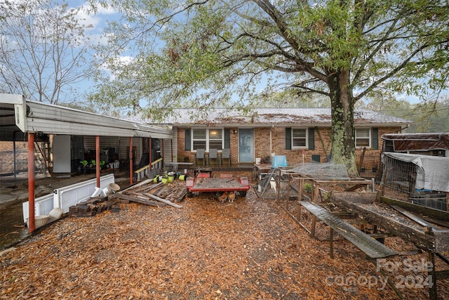 rear view of house featuring a carport