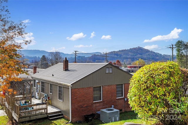 rear view of property featuring a deck with mountain view