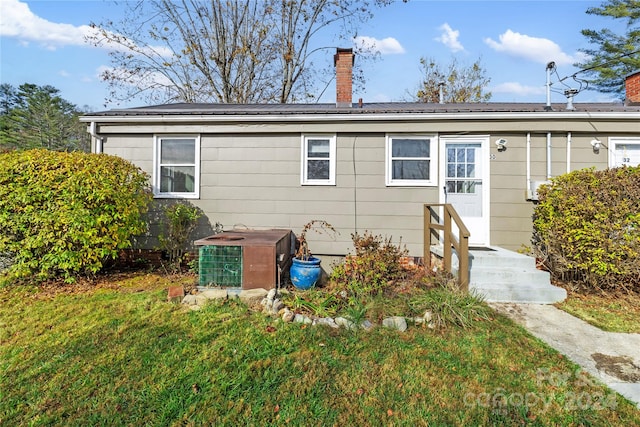 exterior space with a front yard and central air condition unit