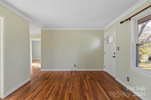 foyer entrance with plenty of natural light, ornamental molding, and dark wood-type flooring