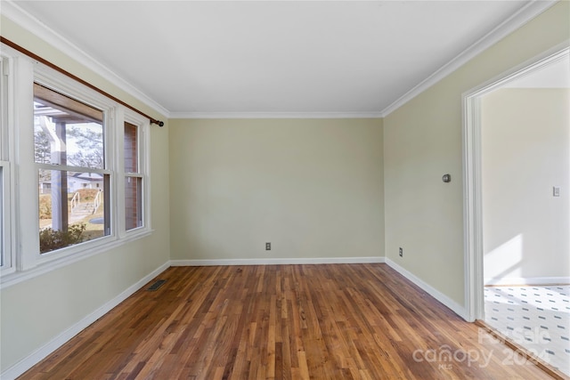 spare room with ornamental molding and dark wood-type flooring