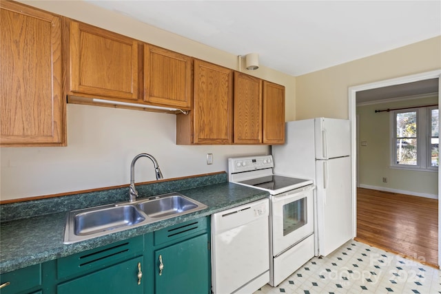 kitchen featuring sink, white appliances, and light hardwood / wood-style flooring