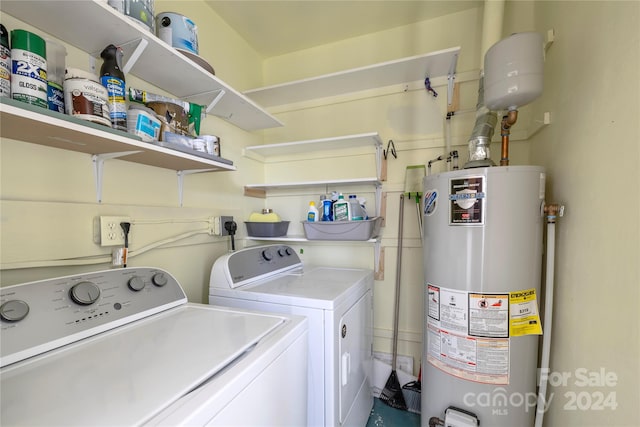 laundry room with separate washer and dryer and water heater