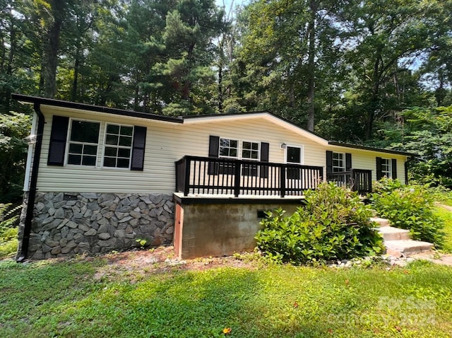 view of front of property with a front lawn and a wooden deck