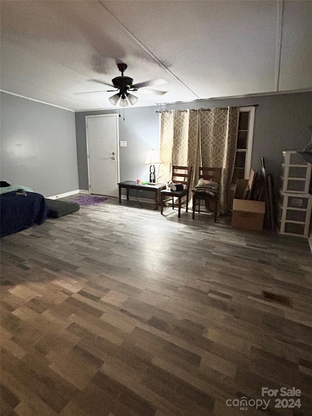 interior space with dark wood-type flooring and ceiling fan