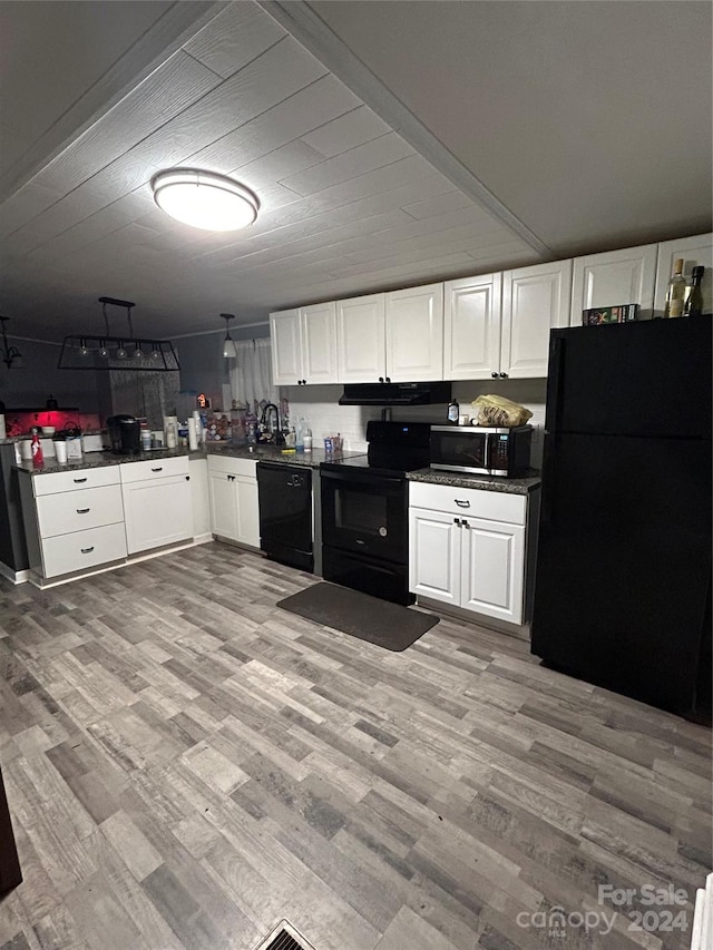 kitchen with white cabinets, light hardwood / wood-style floors, and black appliances