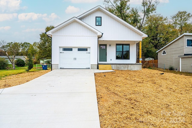 modern farmhouse featuring a garage and a front lawn