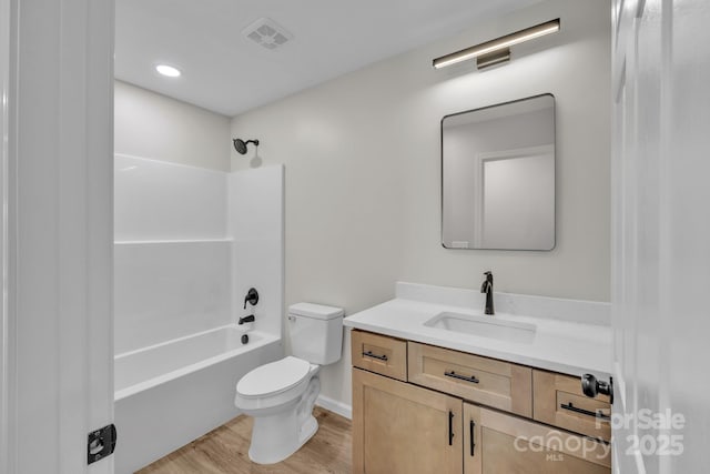 full bathroom featuring  shower combination, toilet, hardwood / wood-style floors, and vanity