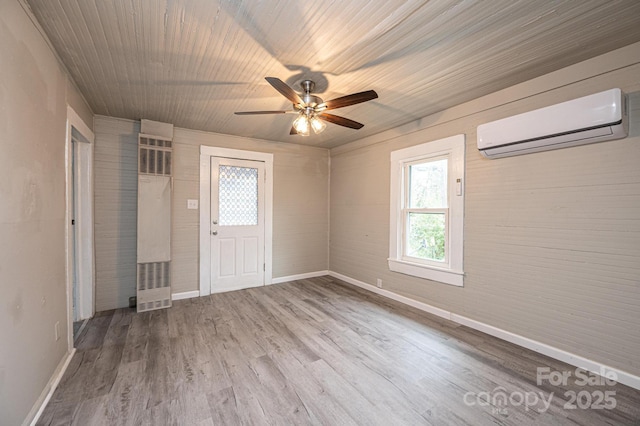 foyer with a wall mounted air conditioner, hardwood / wood-style floors, ceiling fan, and wooden ceiling