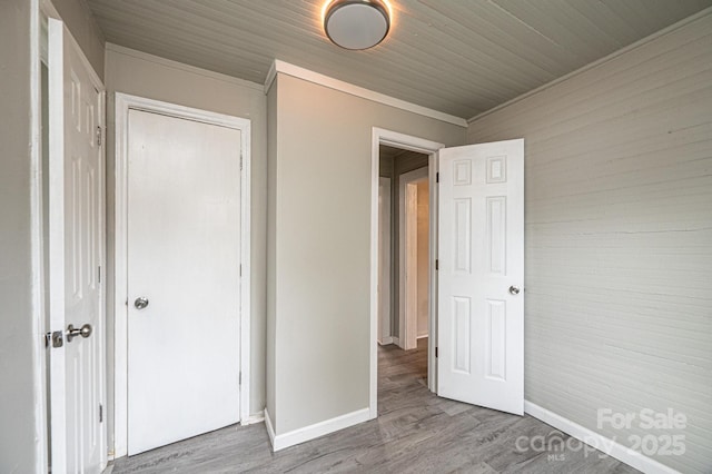 unfurnished bedroom with wood-type flooring and a closet