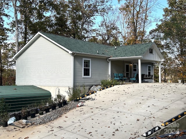 rear view of house featuring a porch