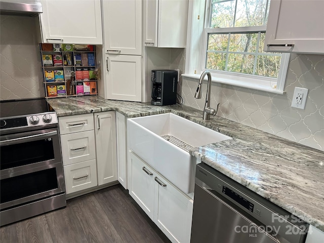 kitchen with white cabinets, dark hardwood / wood-style floors, and appliances with stainless steel finishes