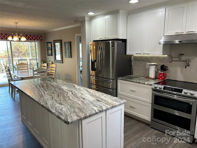 kitchen with white cabinets, stainless steel appliances, an inviting chandelier, and dark wood-type flooring