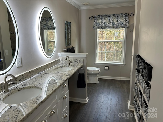 bathroom with vanity, hardwood / wood-style flooring, toilet, and ornamental molding