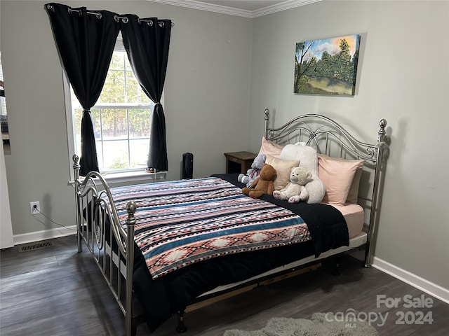 bedroom with dark hardwood / wood-style floors and ornamental molding