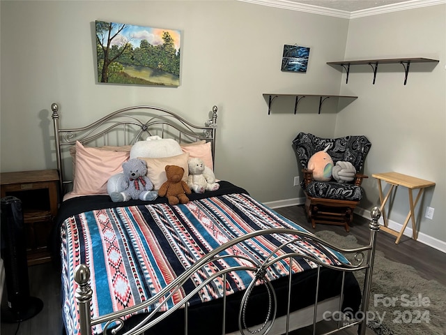 bedroom with dark hardwood / wood-style flooring and crown molding