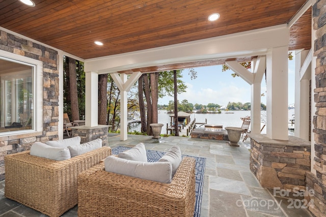 view of patio with a water view