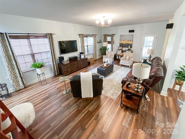 1096 Mountain Laurel Ct, Matthews, NC 28104 - living room with wood finished floors, a chandelier, and plenty of natural light