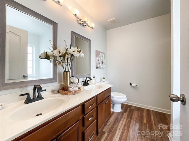 1096 Mountain Laurel Ct, Matthews, NC 28104 - full bathroom featuring wood finished floors, double vanity, toilet, and baseboards