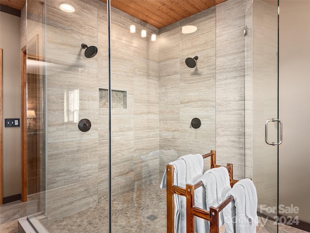 bathroom with wood ceiling and a shower with shower door