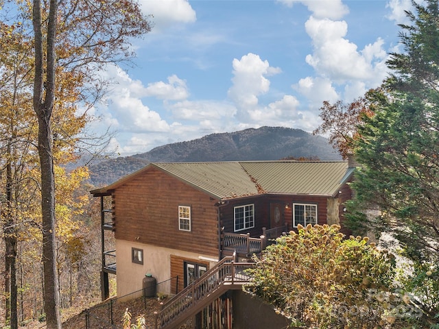 rear view of house featuring a deck with mountain view