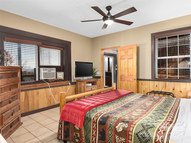 bedroom with light tile patterned flooring, cooling unit, and wood walls