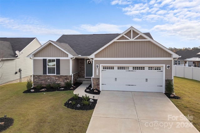 craftsman house with a front yard and a garage