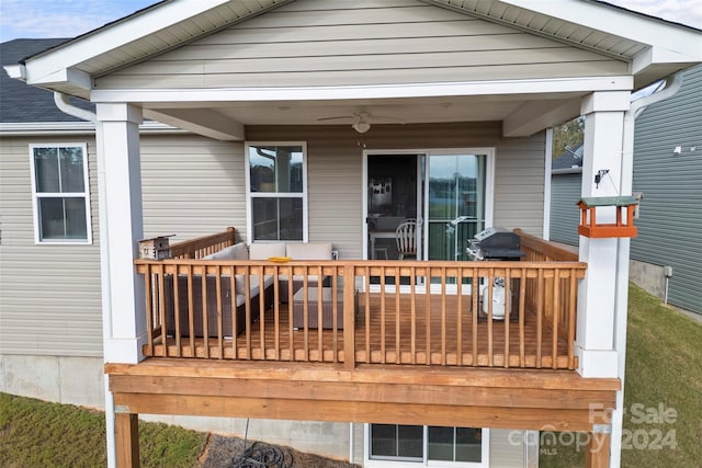 wooden deck with area for grilling and ceiling fan