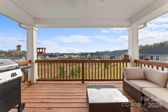 wooden terrace with an outdoor living space