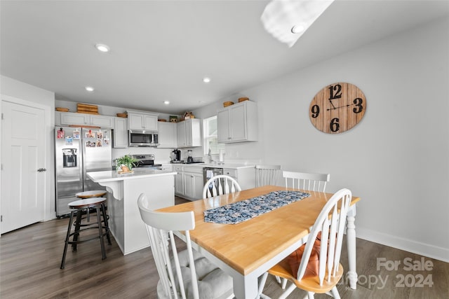 dining area featuring dark wood-type flooring