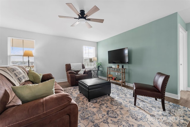 living room featuring ceiling fan and hardwood / wood-style floors