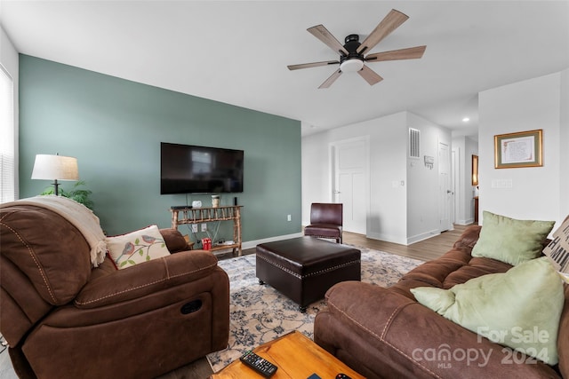 living room featuring hardwood / wood-style floors and ceiling fan