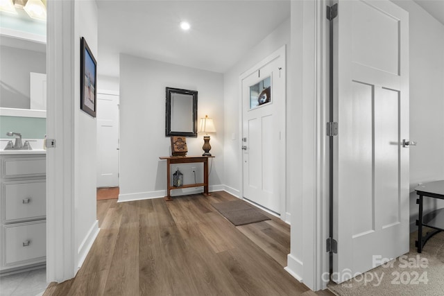 corridor featuring hardwood / wood-style flooring and sink